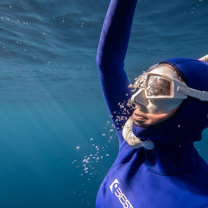 female freediver approaching the surface