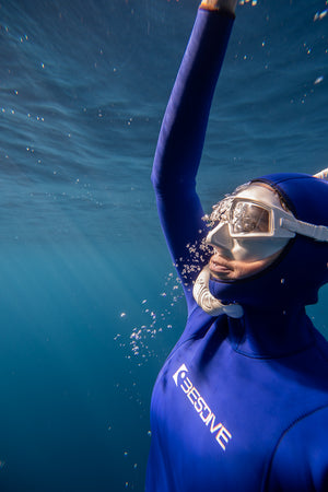 female freediver approaching the surface